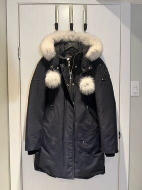 Moose Knuckles Black Parka with White Fur Trim and Pom Accents